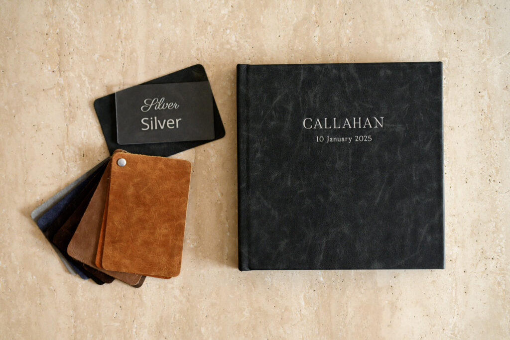 Newborn heirloom album with distressed leather cover and custom silver foil debossing